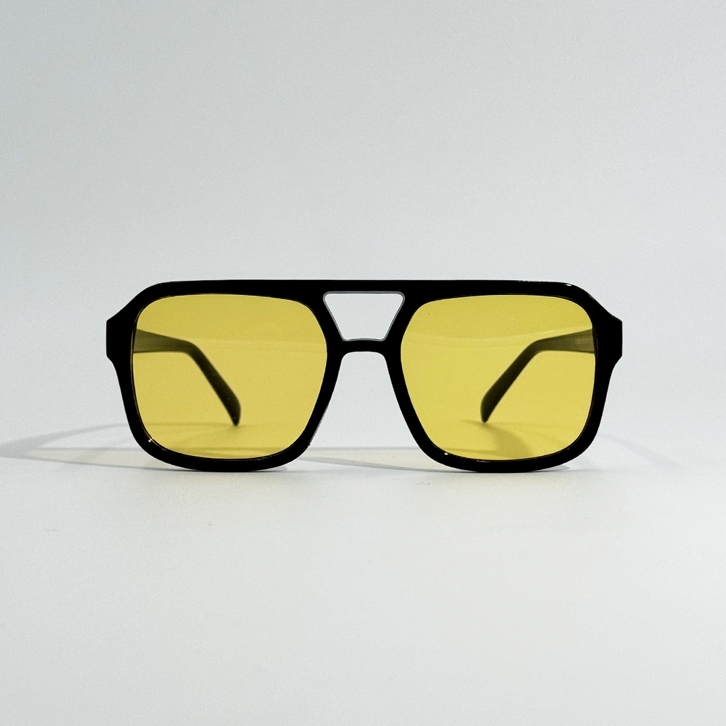 Amber pilot sunglasses with black polycarbonate frame and yellow lenses.