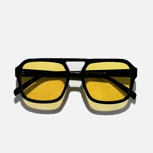 Amber pilot sunglasses with black polycarbonate frame and yellow lenses.
