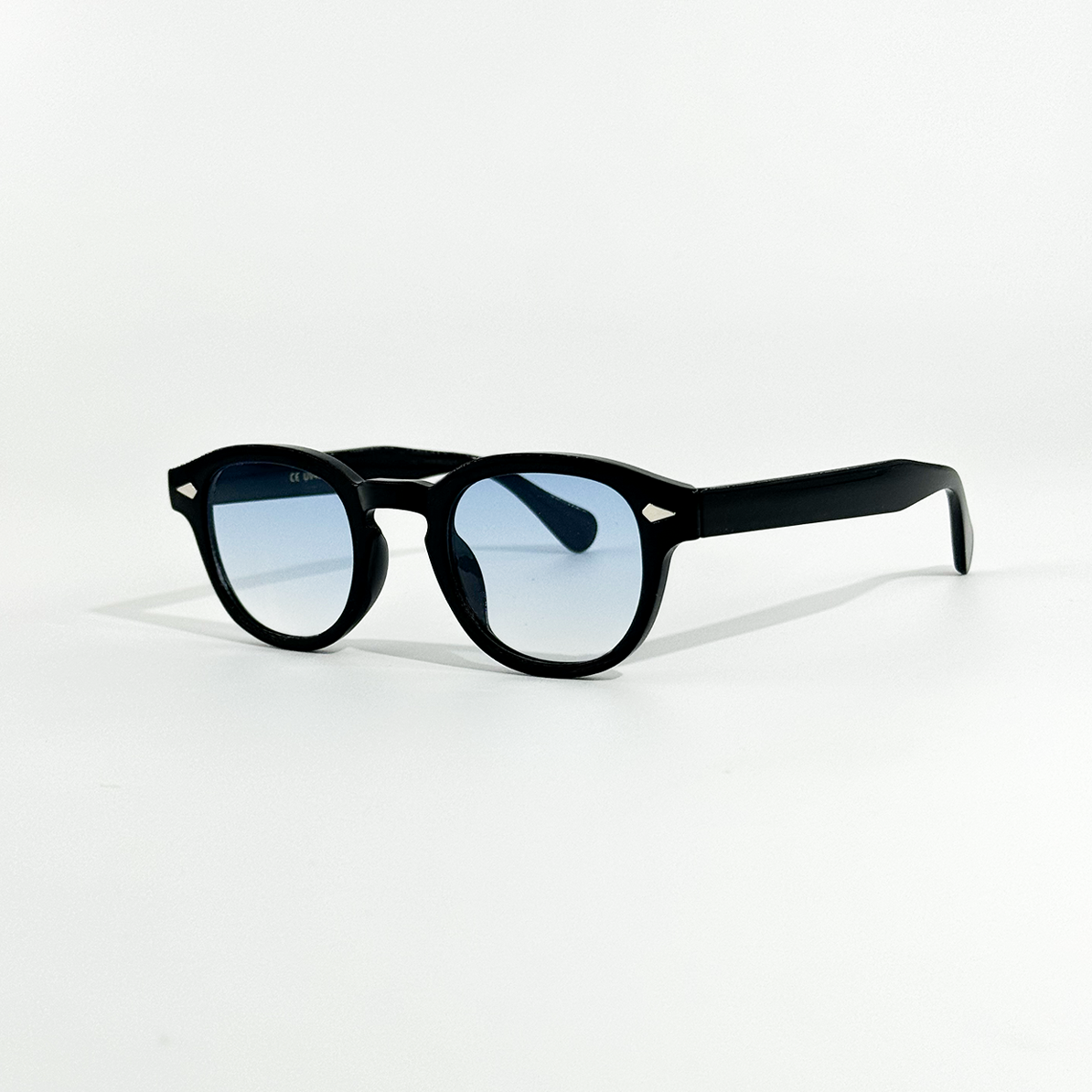 Azure Noir black frame sunglasses with light blue gradient lenses and white temple accents.