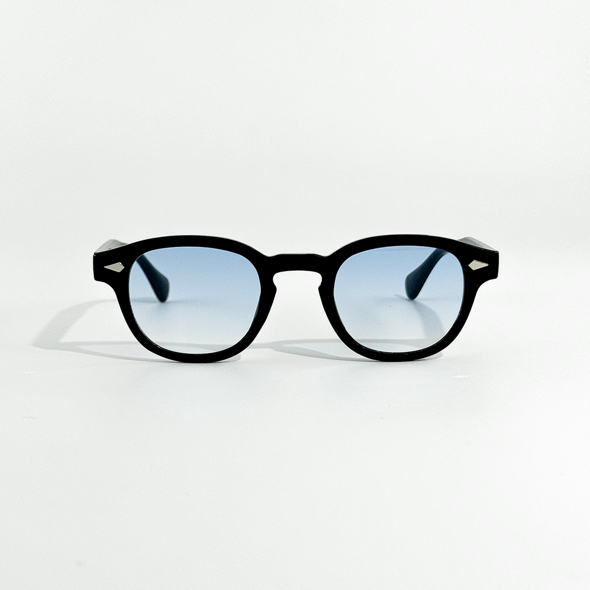 Black SS26 Circle Collection sunglasses with light blue gradient lenses and silver temple accents.