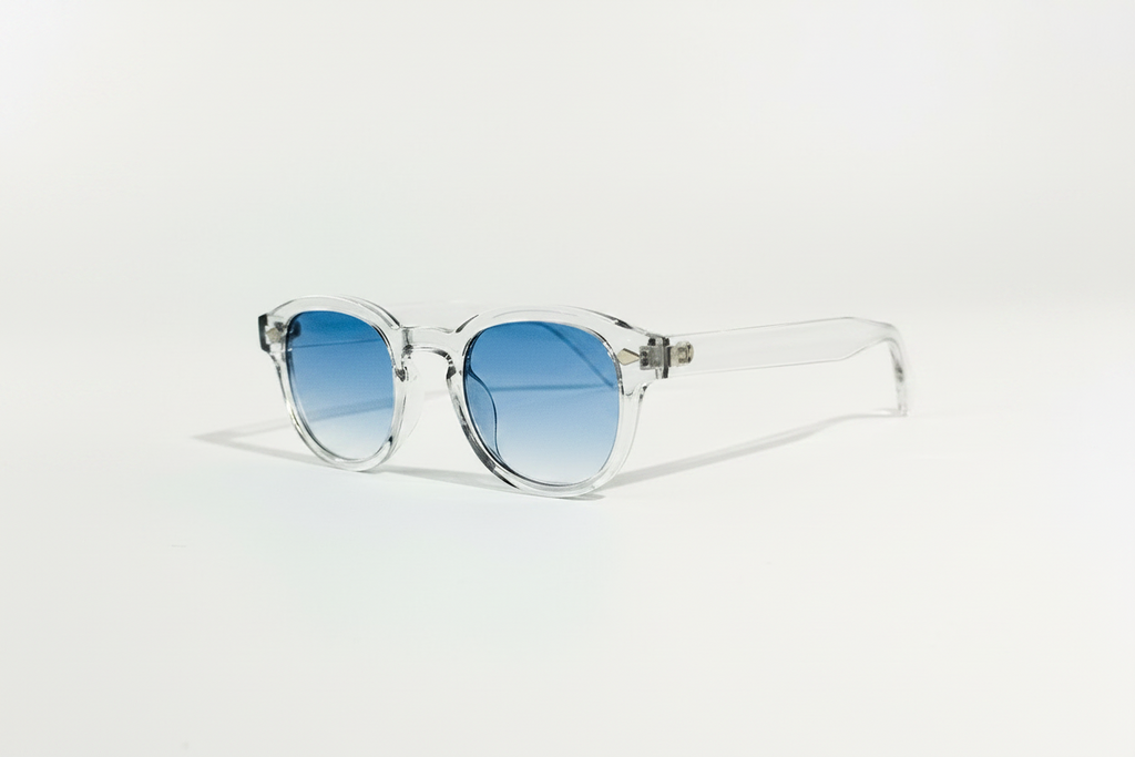 Blue Clarity transparent frame sunglasses with round blue gradient lenses.