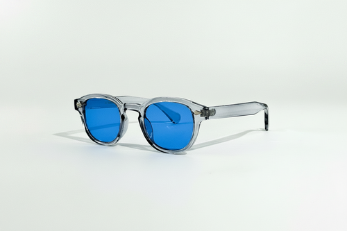 Blue Mirage Circle Collection sunglasses with translucent grey frames and vibrant blue lenses.