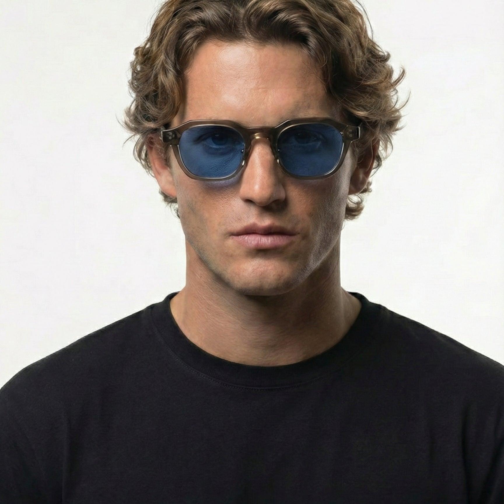 Man wearing Blue Mist Grey Crystal Frame Panto Sunglasses with blue UV400 lenses.