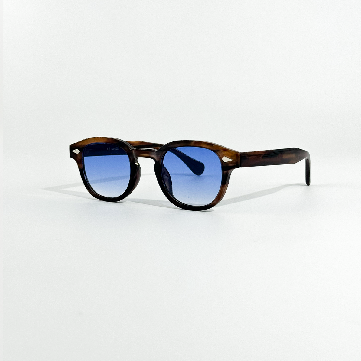 Blue Turtle SS26 Circle Collection sunglasses with dark blue lenses and a brown tortoiseshell frame.