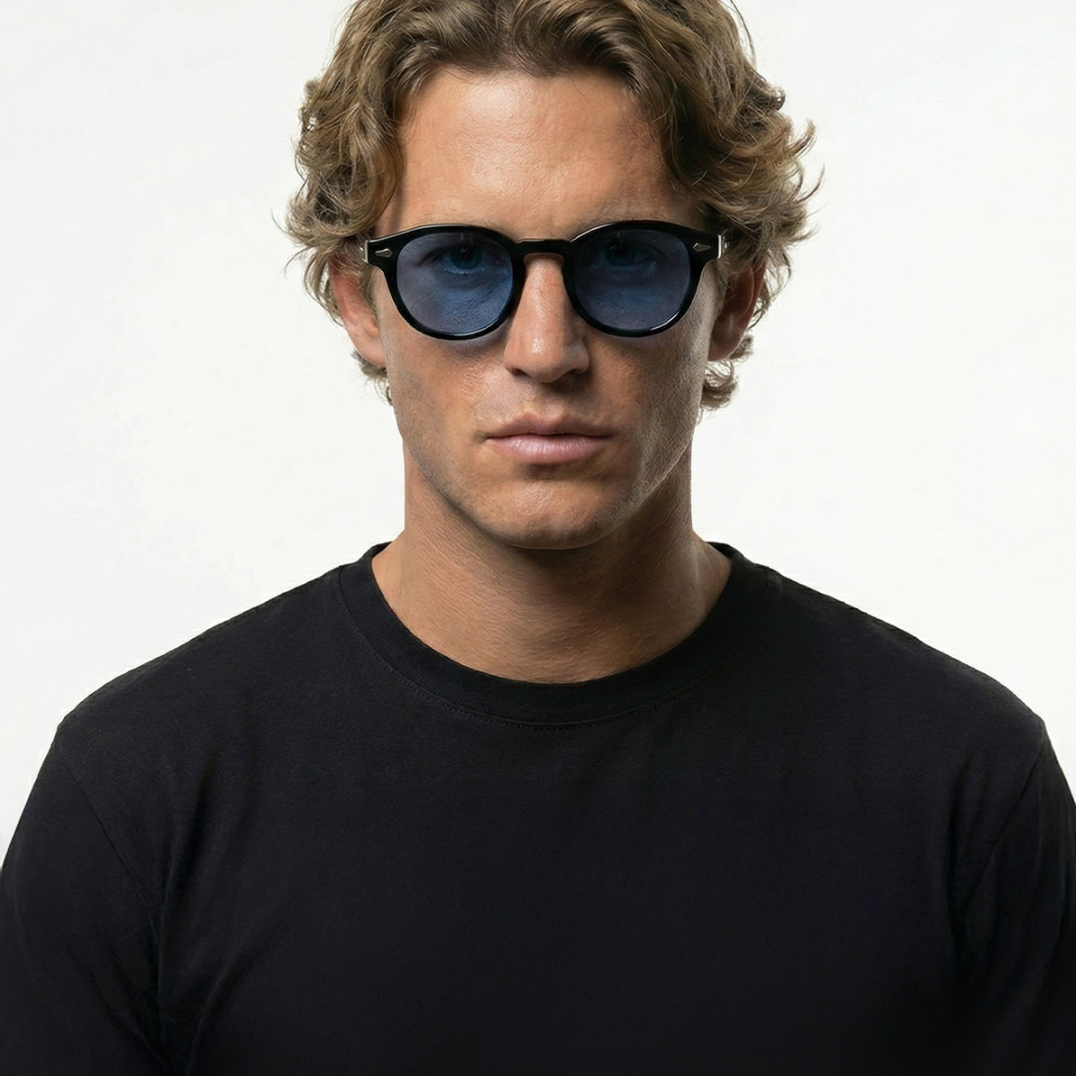 Man wearing Blue Turtle dark blue lens round sunglasses with black frames.
