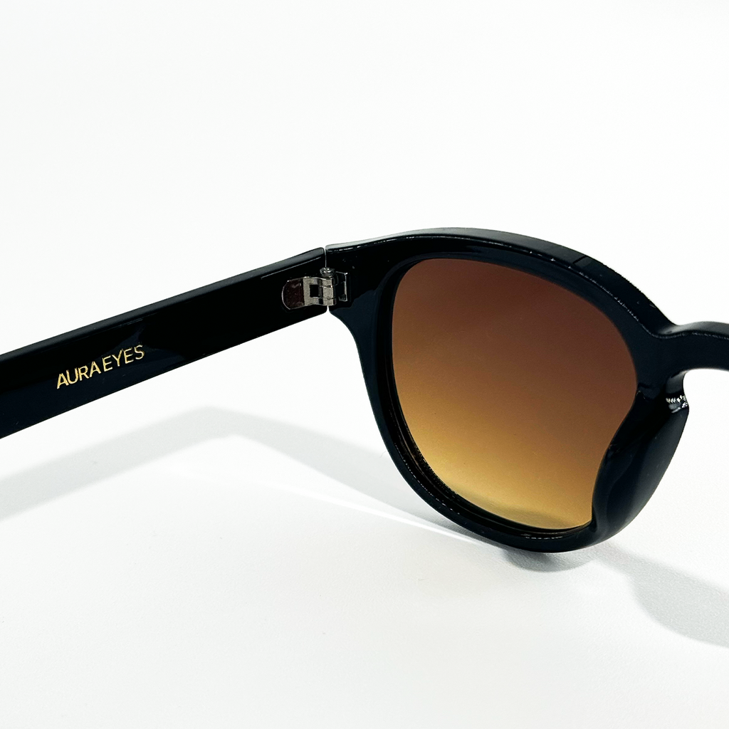 Choco Chic brown gradient sunglasses with black frames and "AURA EYES" in gold on the temple.