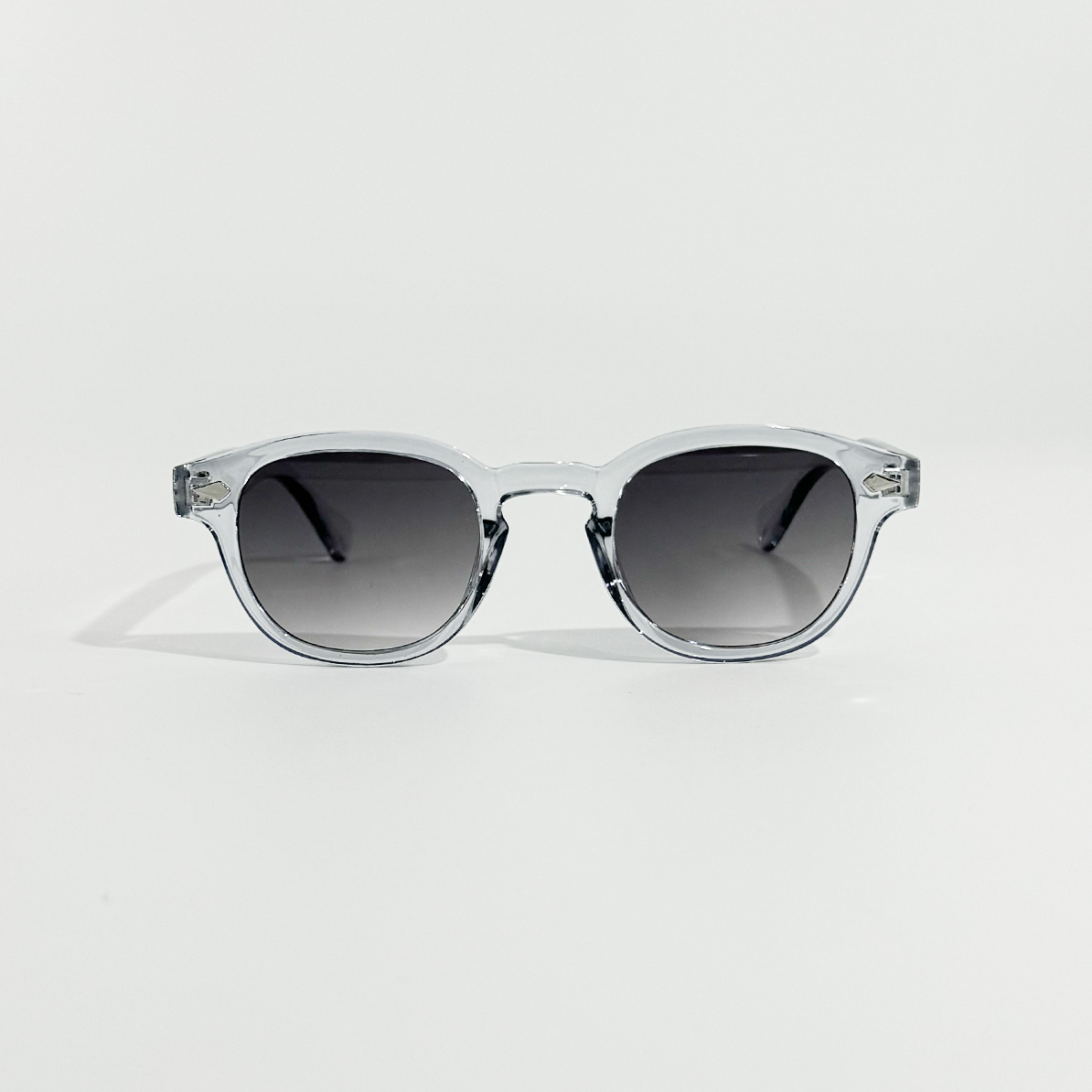 Crystal Tide transparent frame sunglasses with dark gradient lenses, offering UV 400 protection.