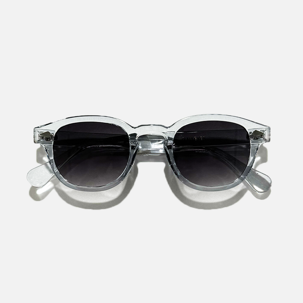 Crystal Tide transparent frame sunglasses with round black lenses, offering UV 400 protection.