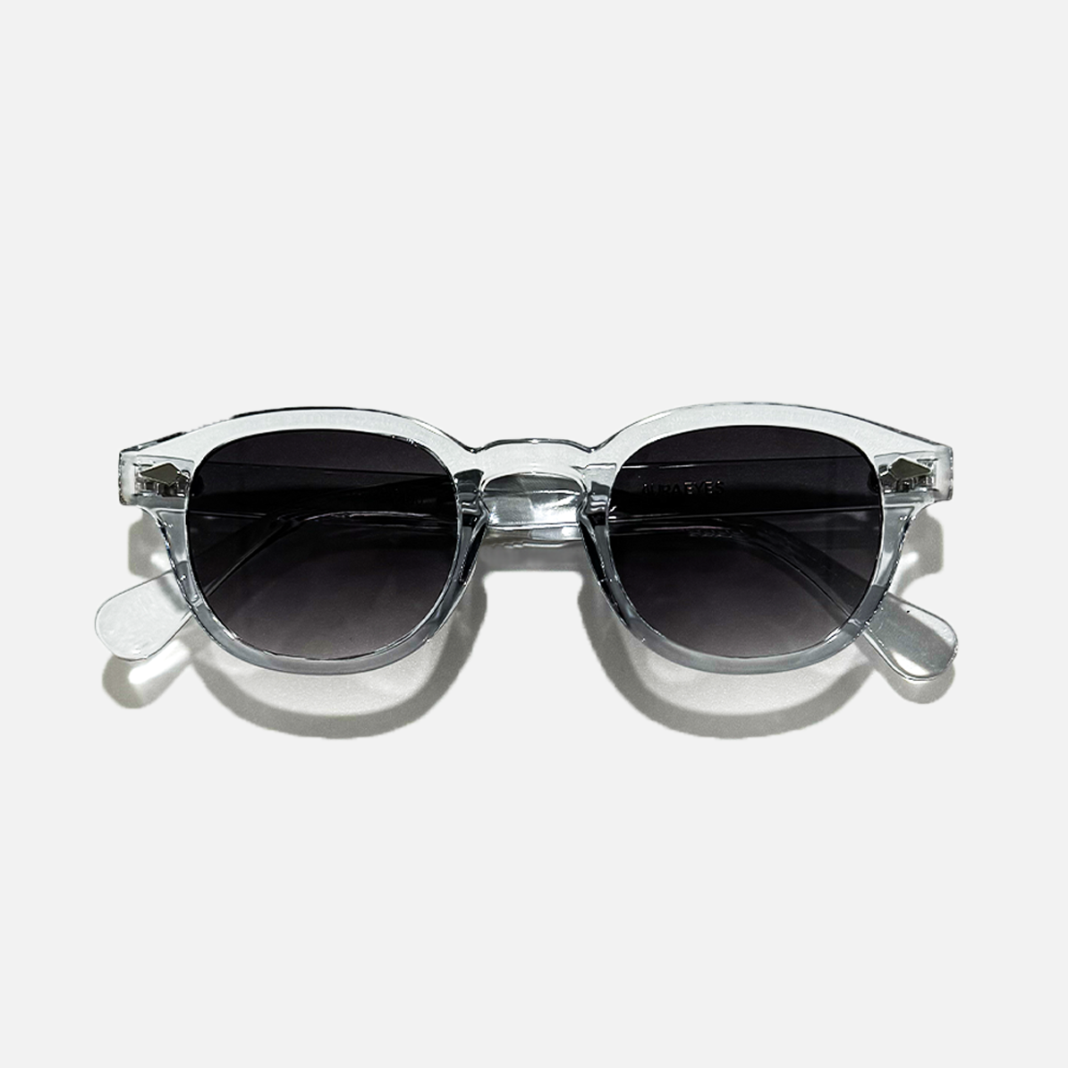 Crystal Tide transparent frame sunglasses with round black lenses, offering UV 400 protection.
