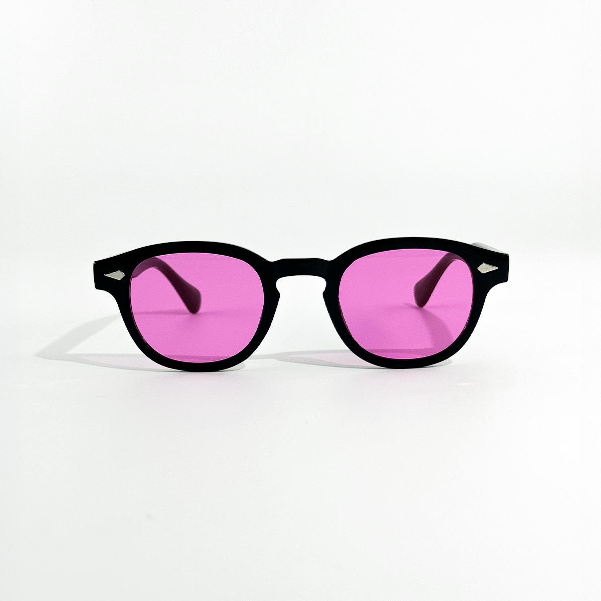 Black frame SS26 Circle sunglasses with vibrant rose pink mirrored lenses.