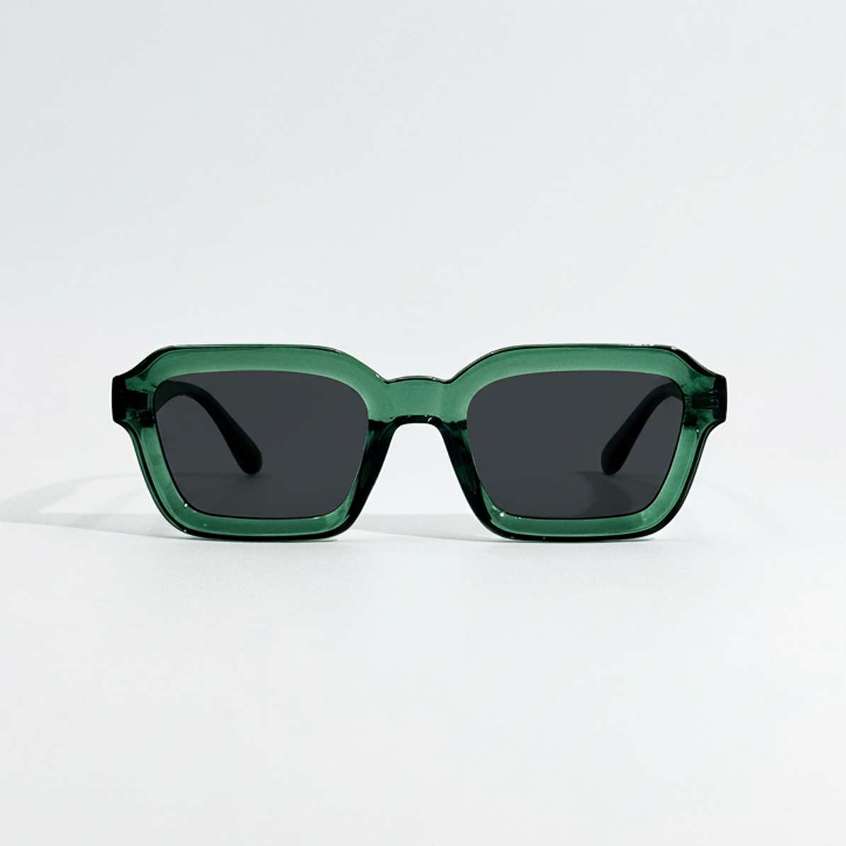 Emerald Tide green crystal frame sunglasses with dark lenses.