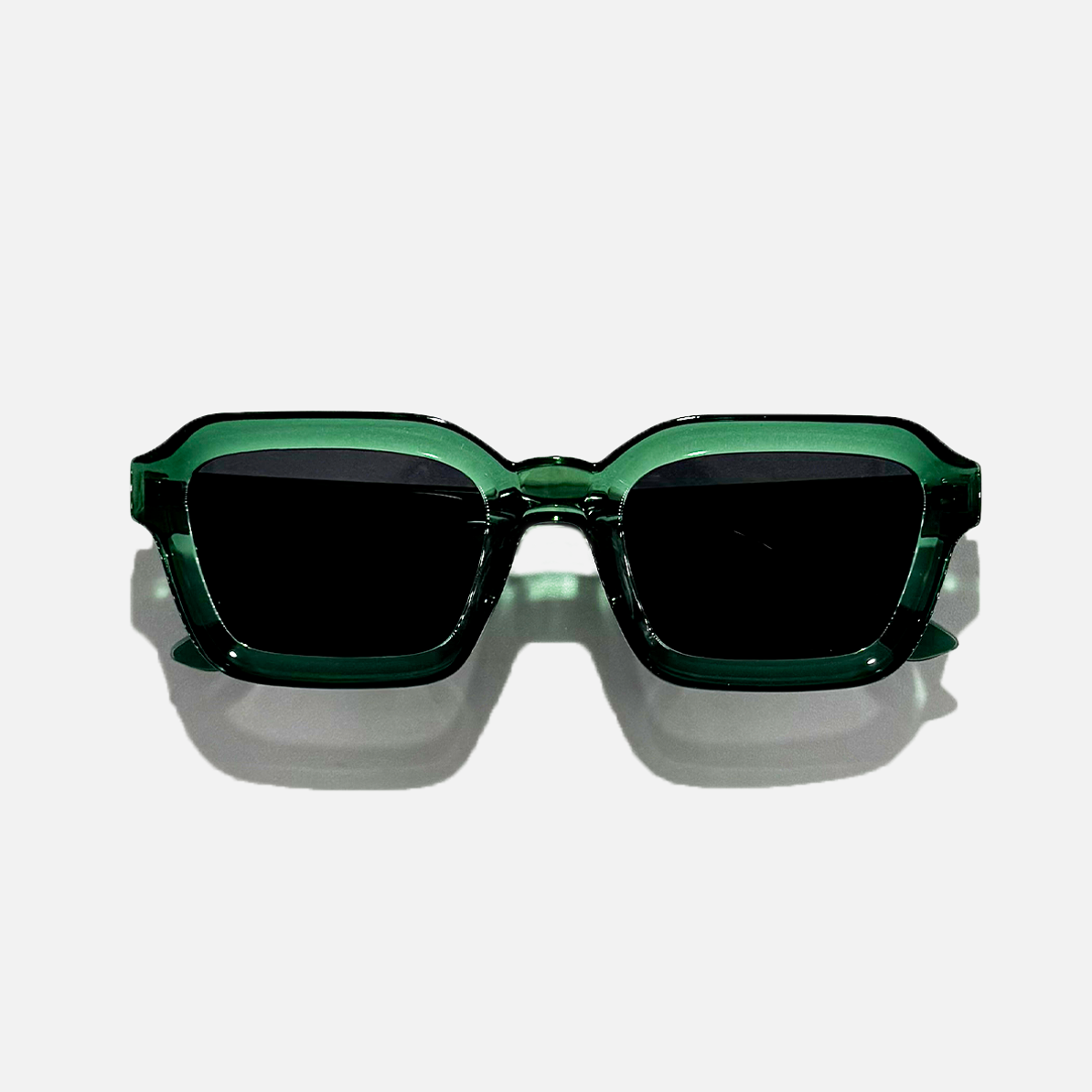 Emerald Tide green crystal frame sunglasses with dark UV400 lenses on a white background.