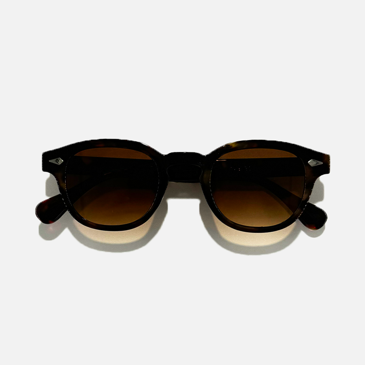Golden Havana brown lens sunglasses with round frames and silver accents.