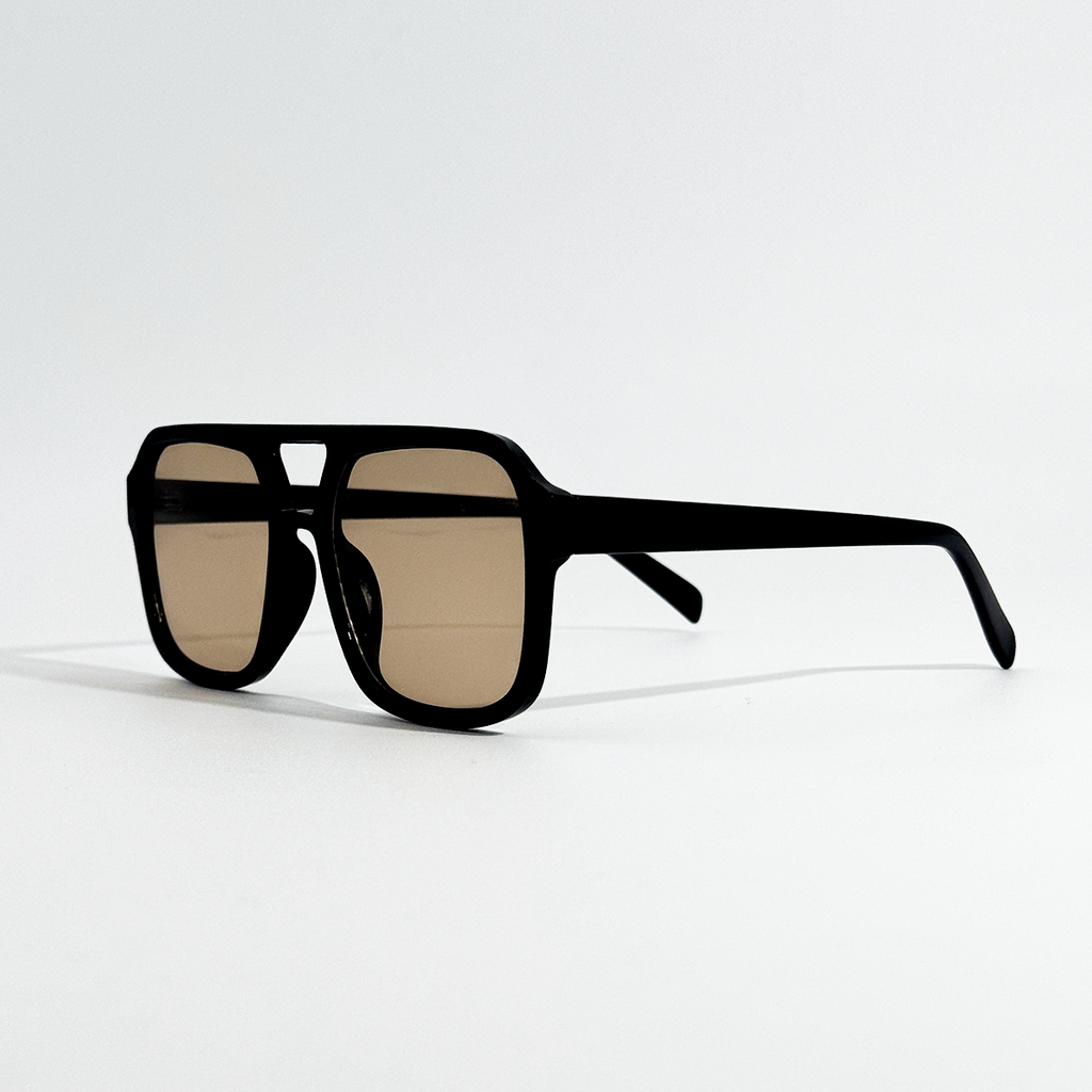 Golden Noir retro sunglasses with a black frame and gold lenses, angled on a white background.