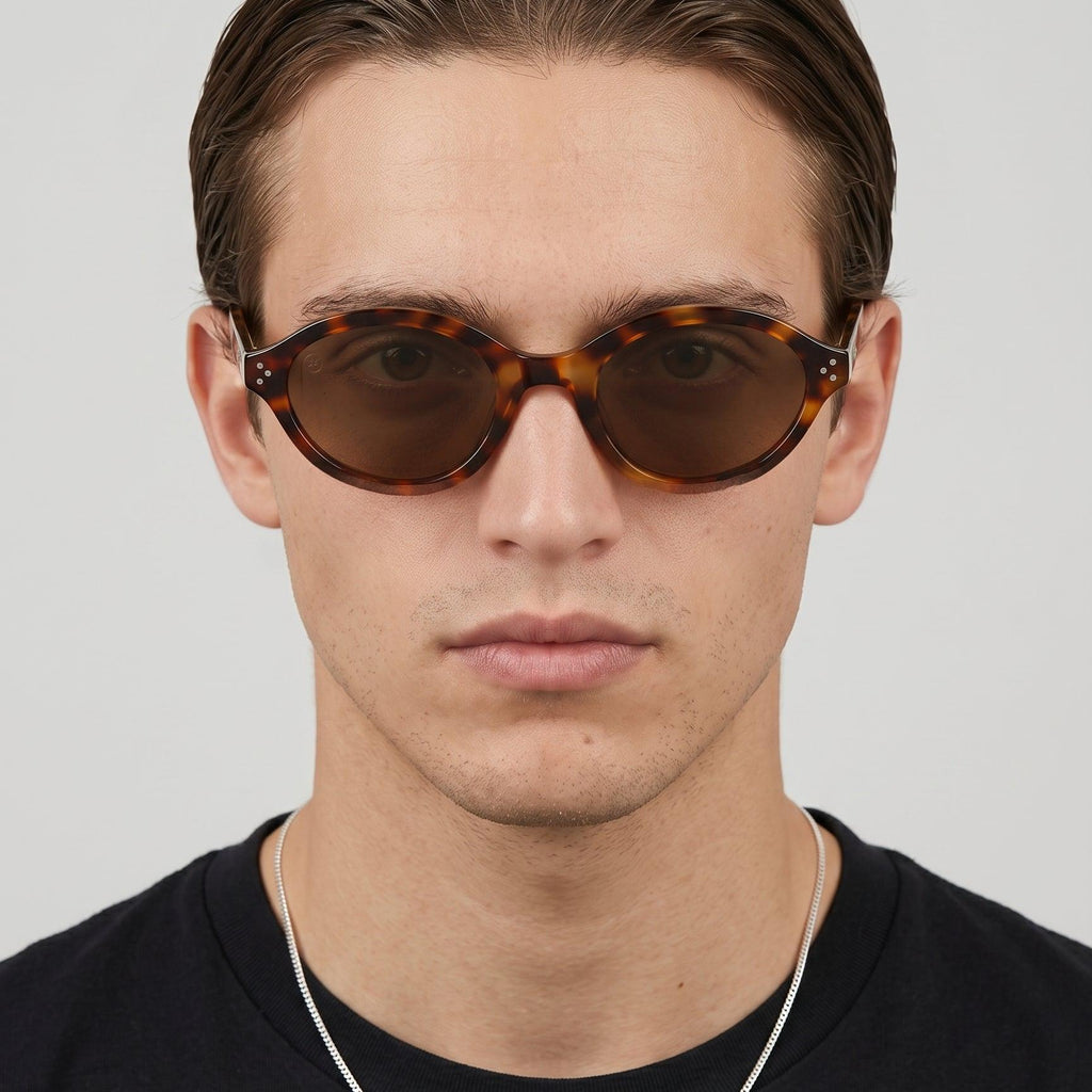 Man wearing Havana Muse Dark Havana Brown Lens Oval Sunglasses.
