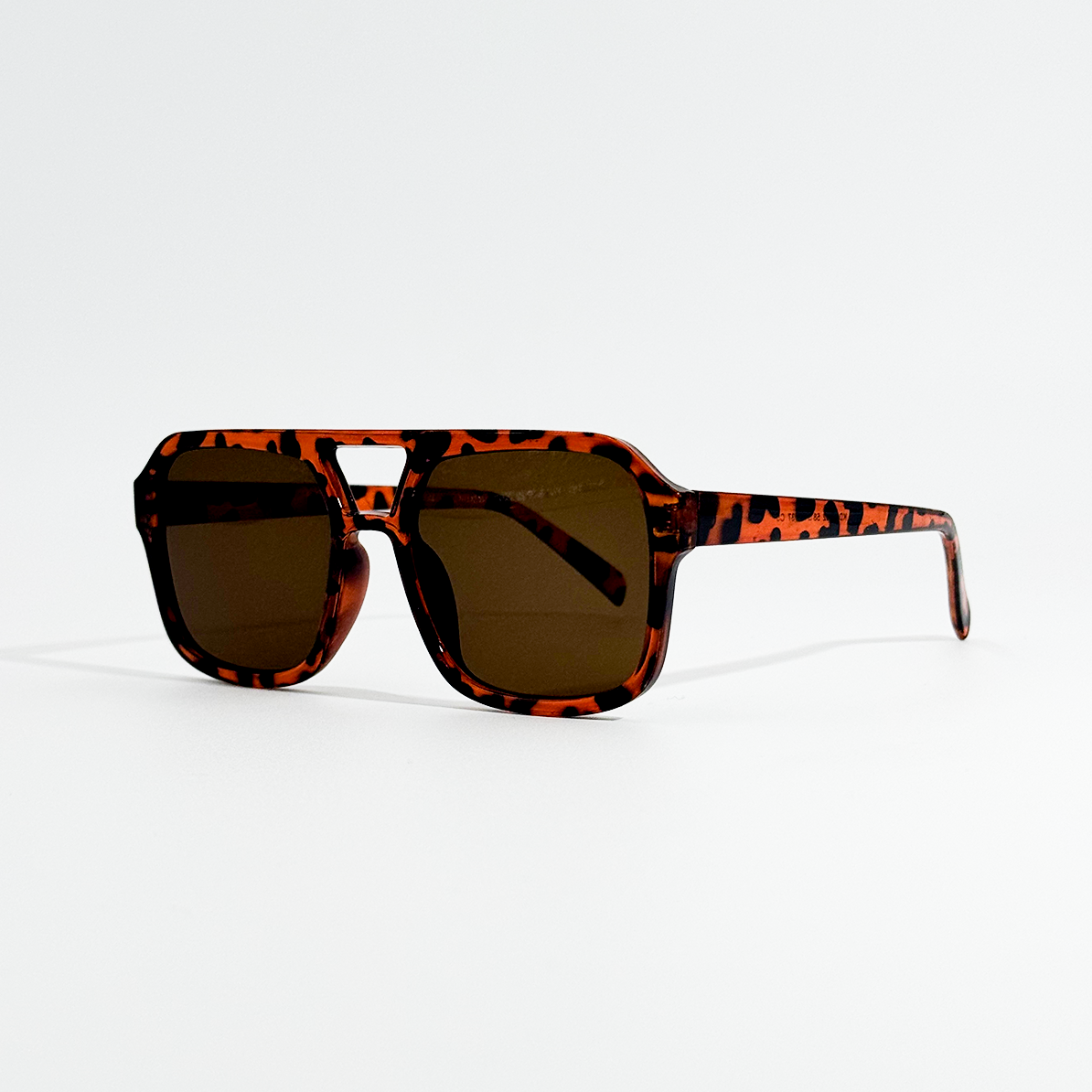 Havana pilot sunglasses with dark black lenses and a retro tortoise shell frame.