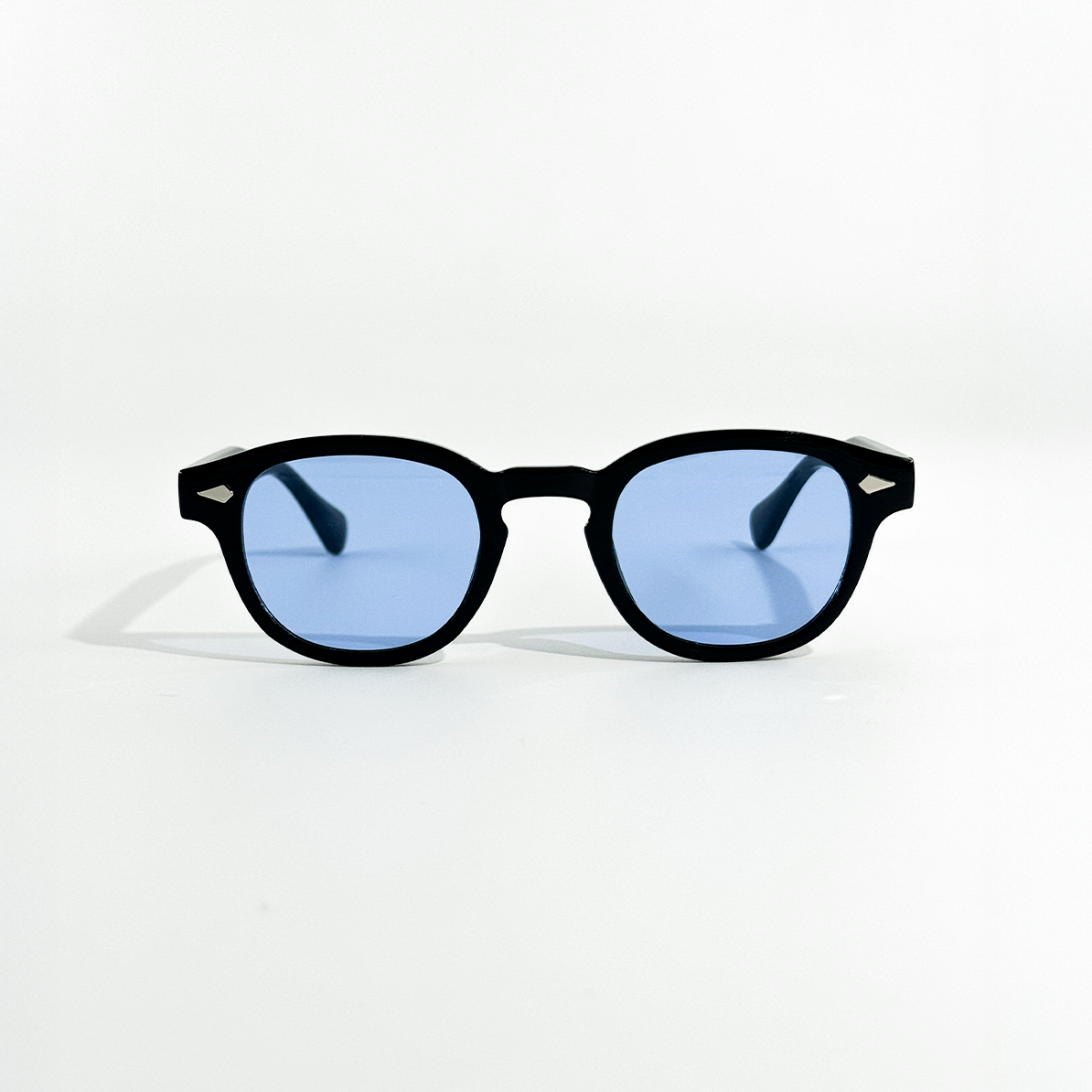 Black SS26 Circle Collection sunglasses with mystical sky blue lenses and UV 400 protection.