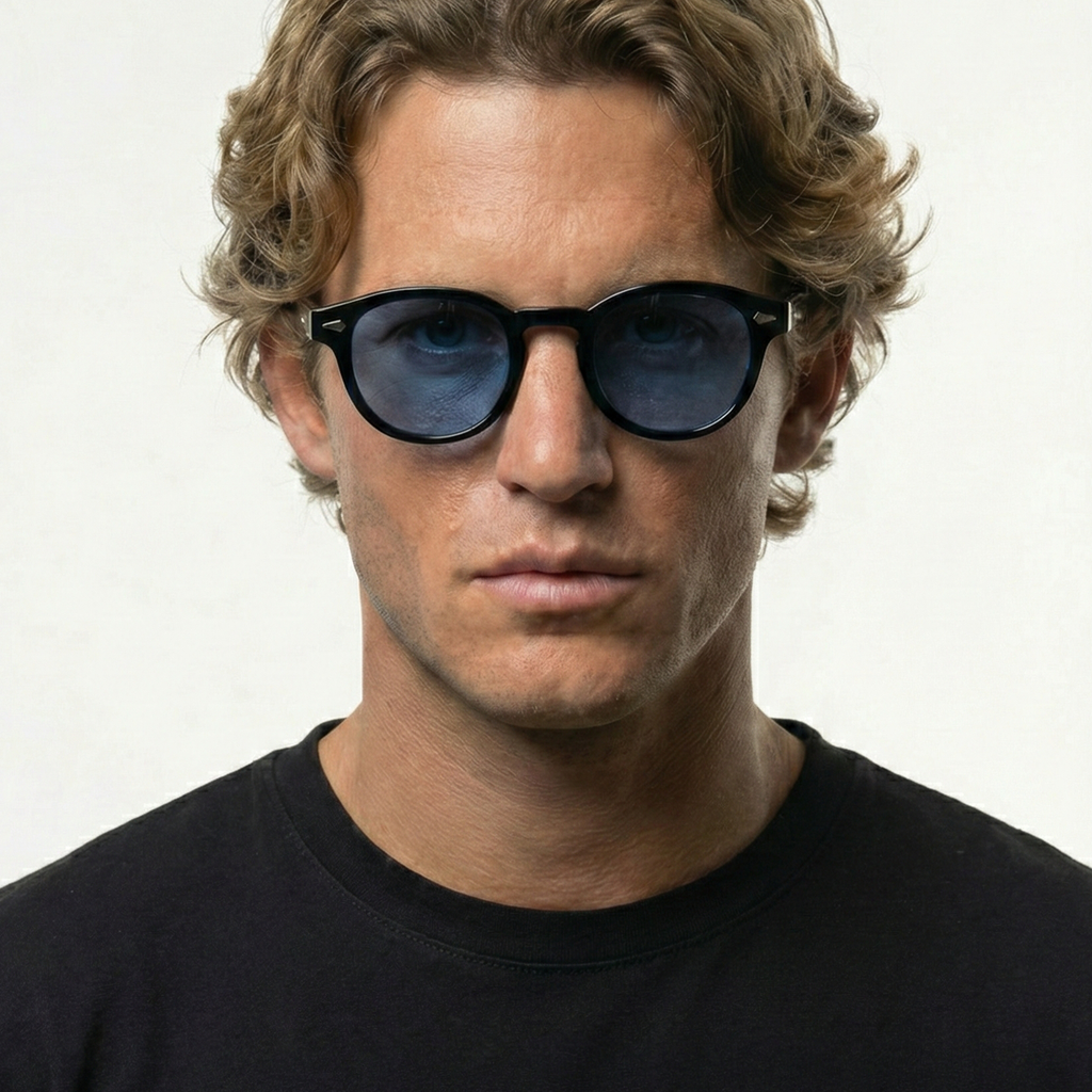 Man wearing round black sunglasses with mystical sky blue lenses.
