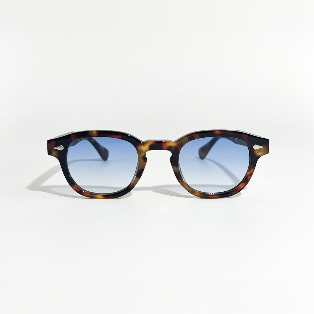 Ocean Amber Blue Gradient Sunglasses with round tortoise shell frames.