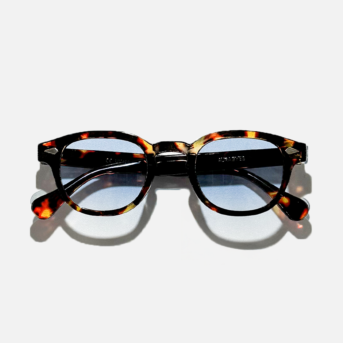 Tortoiseshell circle sunglasses with ocean amber blue gradient lenses, SS26 collection.