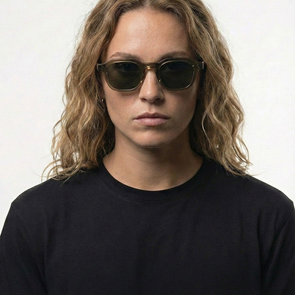 Woman wearing Silver Shadow Black Frame Silver Gradient Panto Sunglasses with mineral green lenses.